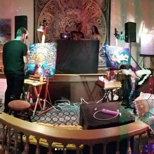 Monet Fort painting at a live event at an old church