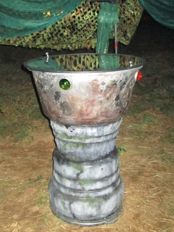 scrying mirror at night, stone column with silver bowl and two-way mirror on top