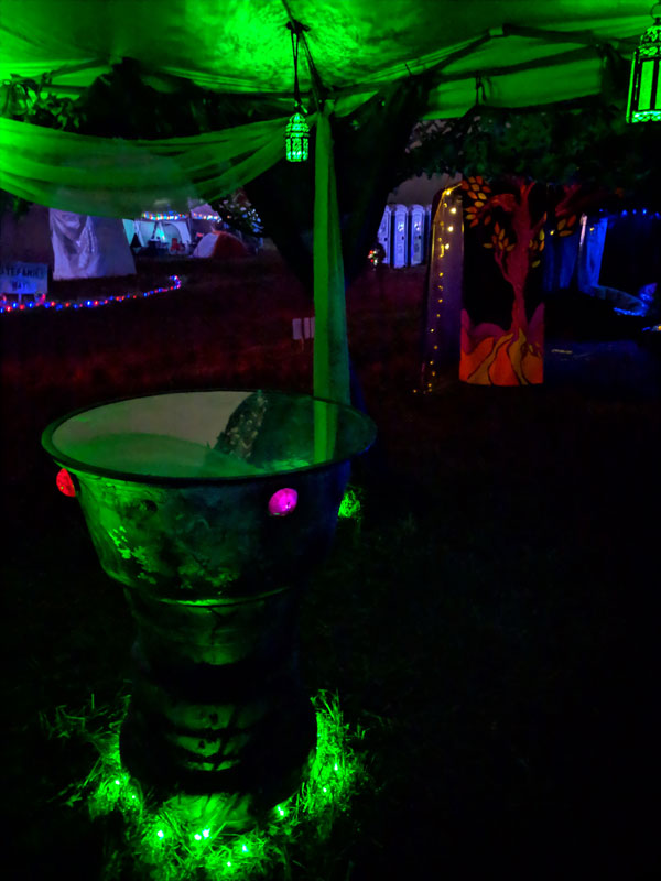 scrying mirror under a green-light canopy at night