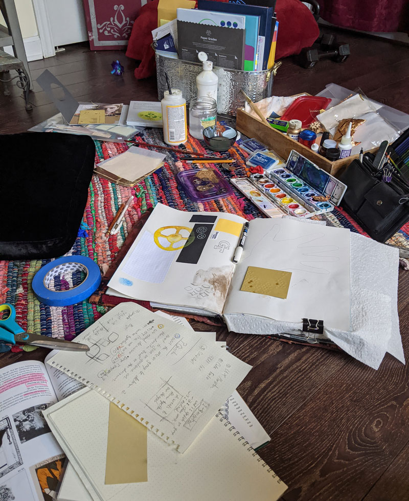 an assortment of art supplies strewn on the floor